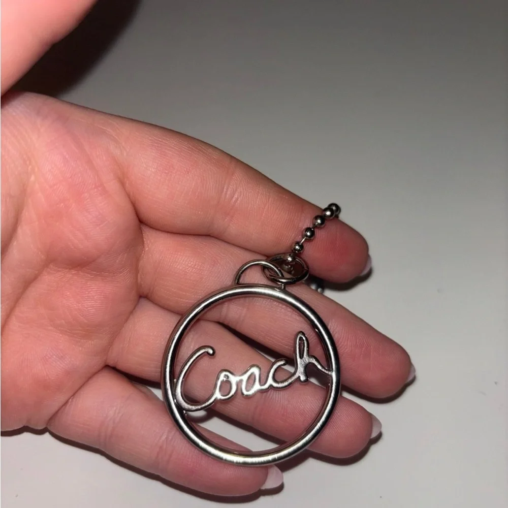 Coach round silver script spellout metal hang tag purse charm chain